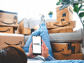 Amazon shopper surrounded by Amazon package boxes